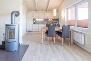 a kitchen and dining room with a table and chairs at Ferienhaus Strandflieder in Dagebüll