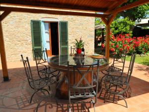 a table and chairs on a patio with flowers at Holiday Home Lucia by Interhome in Cortona