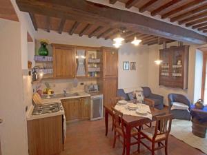 a kitchen and living room with a table and chairs at Holiday Home Lucia by Interhome in Cortona +21 photos