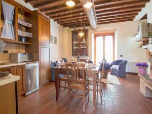 a kitchen and dining room with a table and chairs at Holiday Home Lucia by Interhome in Cortona