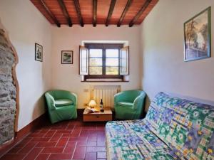 a bedroom with two green chairs and a bed at Apartment Il Gufo n-1 by Interhome in Starda