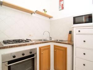 una cucina con lavandino e piano cottura forno superiore di Apartment Carlino by Interhome a Nerano