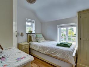 a small bedroom with a bed and a window at Holiday Home Watery Lane by Interhome in Croyde