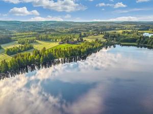 an aerial view of a lake with clouds in the water at Holiday Home Kuikanranta by Interhome in Hara