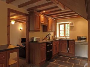 AbergynolwynにあるHoliday Home Y Granar by Interhomeのキッチン(木製キャビネット、コンロ付)