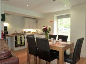 a kitchen and dining room with a table and chairs at Holiday Home Dwy by Interhome in Llithfaen