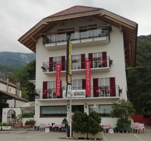 a building with red and yellow signs on it at Pension Flora in Auer