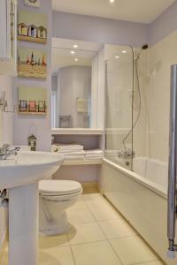 a bathroom with a toilet and a shower and a sink at Apartment Belle View by Interhome in Ilfracombe