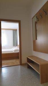 a bathroom with a mirror and a bed in a room at Gästehaus Andreas Kroiss in Illmitz