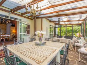 a dining room with a wooden table and chairs at Villa La Casa Vivente by Interhome in Livorno