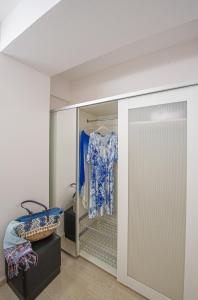 a dressing room with a closet with a door at Cozy Corner Analipsi Apartment in Zakynthos Town