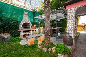 a garden with a stone oven in a yard at Apartment & Rooms Graciela in Rovinj