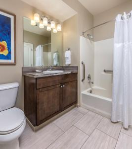 a bathroom with a sink and a tub and a toilet at WorldMark Solvang in Solvang