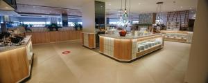 a restaurant with a counter in the middle of a room at Hotel Cristina by Tigotan Las Palmas - Adults Only in Las Palmas de Gran Canaria