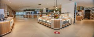 a large kitchen with a counter in a building at Hotel Cristina by Tigotan Las Palmas - Adults Only in Las Palmas de Gran Canaria