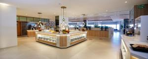 a restaurant with a counter with drinks on it at Hotel Cristina by Tigotan Las Palmas - Adults Only in Las Palmas de Gran Canaria
