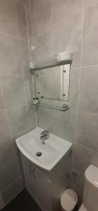 a bathroom with a white sink and a toilet at Beach Cove in Llandudno +23 photos