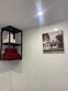 a bathroom with a picture of a bird cage on the wall at Vue mer exceptionnelle, El Rosario (Marbella). in Marbella