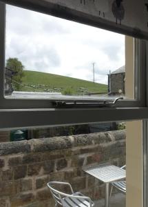 a view from a window of a table and chairs at BELLE VUE - SKIPTON in Skipton