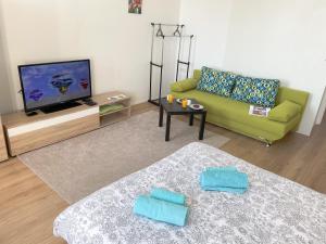 a living room with a couch and a television at Sea star apartments in Rijeka