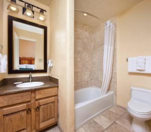 a bathroom with a sink and a toilet and a bath tub at WorldMark Santa Fe in Santa Fe +28 photos