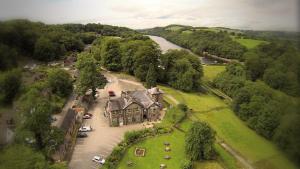 an aerial view of a large house and a river at Hotel Rudyard in Leek