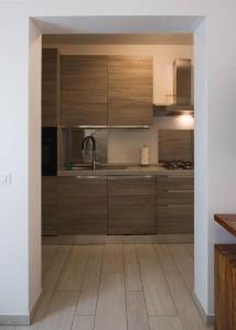 a kitchen with wooden cabinets and a sink at Corte del Tintor Apartments in Venice