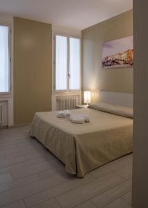 ein Schlafzimmer mit einem Bett mit zwei Handtüchern darauf in der Unterkunft Corte del Tintor Apartments in Venedig