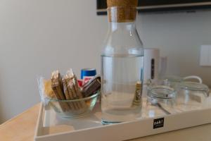 a bottle of water and a bowl of cigarettes at Gaya resort in Benevento