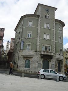 a building with a car parked in front of it at Apartments Popov in Crikvenica