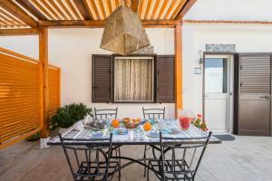 a table with chairs and food on top of it at Villa Cinzia-150 mt from the beach in Mondello