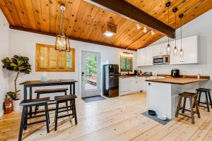 a kitchen with wooden ceilings and a wooden floor at Lily Haus in Idyllwild