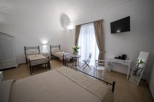 Postel nebo postele na pokoji v ubytování B&B Palazzo Loreto