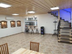 a room with a staircase and a table and chairs at Apgyvendinimas Rusnėje, šalia Pakalnės upė 100m in Rusnė +1 photo