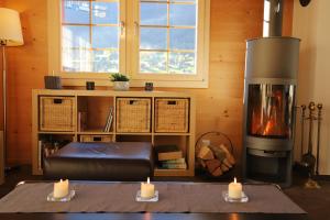 a living room with a fireplace and two candles at Excellent flat with a fantastic view of the Eiger! in Grindelwald