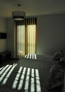 A bed or beds in a room at Canadina 2