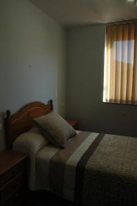 A bed or beds in a room at Canadina 2