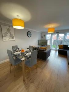 a living room with a table and a couch at The Shires in Nuneaton