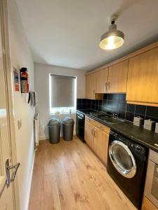 a kitchen with a washer and dryer in a room at The Shires in Nuneaton