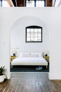 a bedroom with a large bed in a white room at Dye House in Providence