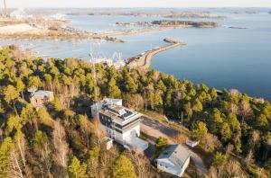 an aerial view of a building on a hill next to the water at Hotel Vanha-Merivartioasema in Kotka