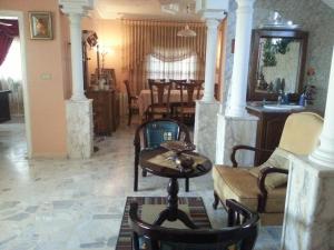 a living room with a table and chairs at Murshed Motel in Ash Shūnah ash Shamālīyah