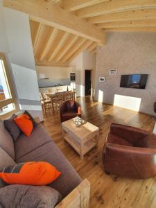 a living room with a couch and a table at Alpen-Park Dachwohnung Ost in Riederalp
