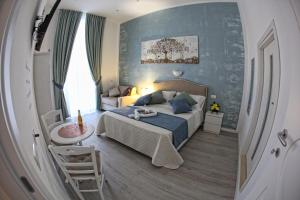 
a bedroom with a bed and a mirror at Maison Nilo 15 in Naples
