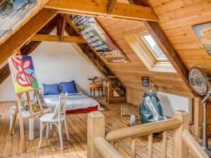 a bedroom with a bed in a room with wooden ceilings at Holiday Home Le Patio by Interhome in Saint Malo