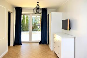 TV a/nebo společenská místnost v ubytování Apartamenty Royal Maris 7 - najlepsza lokalizacja w Ustce, blisko plaży i portu, bezpłatny parking, ścisłe centrum