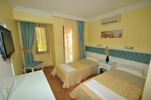 Postel nebo postele na pokoji v ubytování İlkiz Beach Hotel