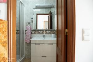 a bathroom with a sink and a mirror at NVidas in Figueira da Foz