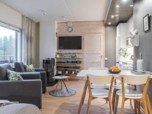 a living room with a couch and a table at Holiday Home Levin stara a08 by Interhome in Sirkka