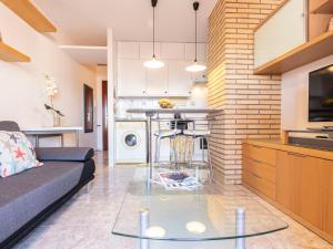 a living room with a couch and a glass table at Apartment Torrepuerto by Interhome in Torredembarra